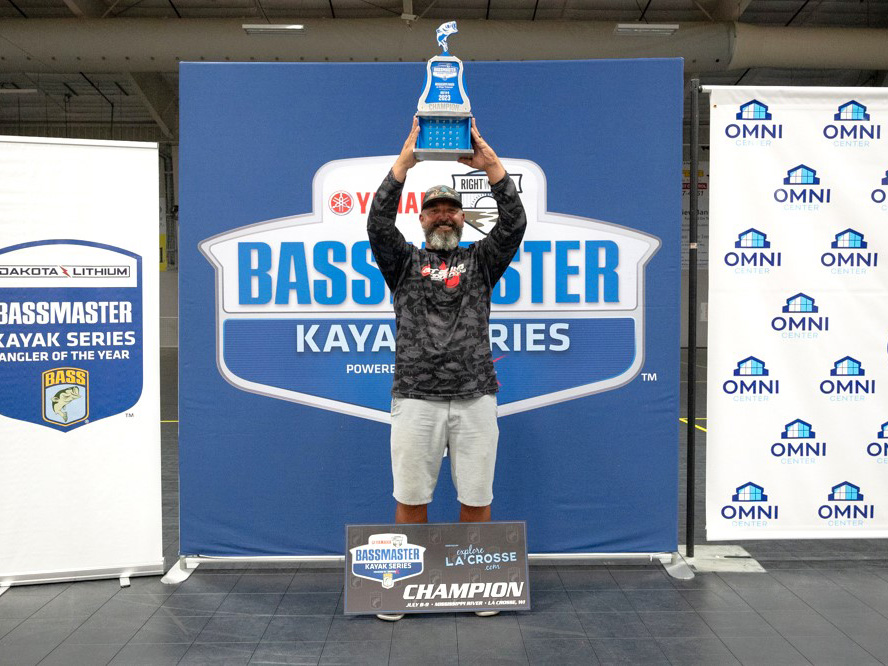 Tyler Cole holding Bassmaster Kayak Series trophy